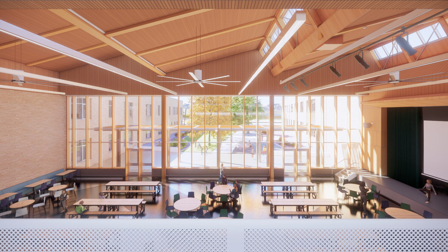 Rendering of Big Sky PK-8 common area including lunch tables, large window, and auditorium stage.